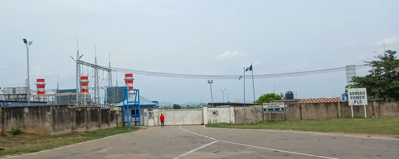 The entrance to Geregu Power Plc's gas-fired power station in Kogi State, with exhaust stacks, a switchyard and…