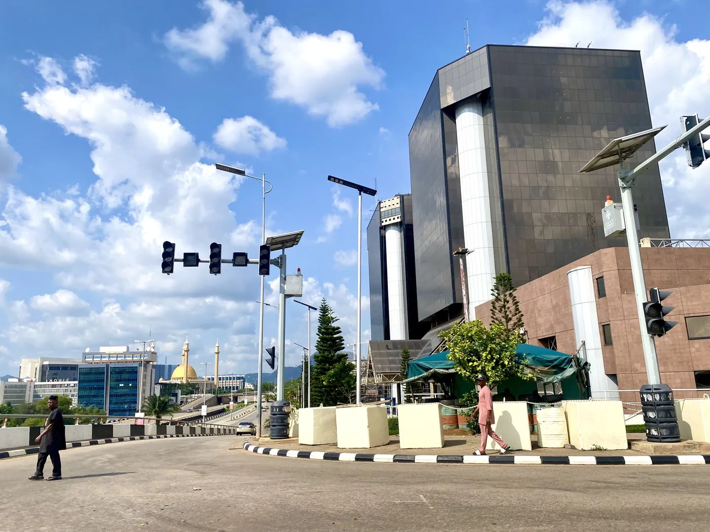 NNPC Towers, the headquarters of NNPC Limited in the Central Business District of Abuja, seen from a road junction in July 2026