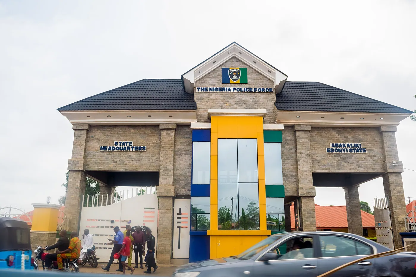 Gate of the Nigeria Police Force state headquarters in Abakaliki, Ebonyi State, with traffic passing in front