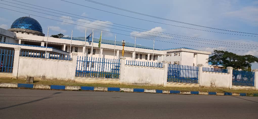 The Rivers State House of Assembly complex in Port Harcourt, seen from the road behind its blue railings